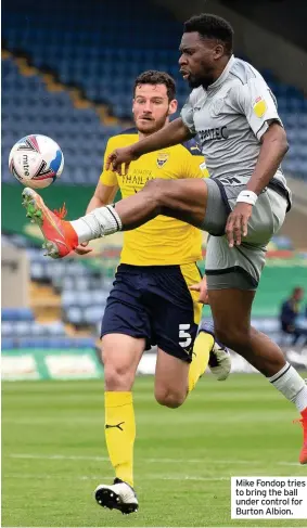  ??  ?? Mike Fondop tries to bring the ball under control for Burton Albion.