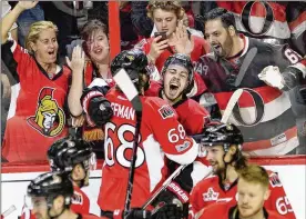  ?? ADRIAN WYLD / AP ?? Jean-Gabriel Pageau (center) rejoices with Mike Hoffman after scoring the winning goal and giving the Senators a 2-0 series lead against the Rangers.