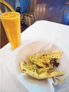  ?? ?? Naan & Dosa’s mango lassi and garlic naan.