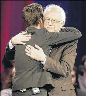  ?? CHUCK BURTON / ASSOCIATED PRESS ?? Democratic presidenti­al candidate Sen. Bernie Sanders, I-Vt., hugs MSNBC’s Rachel Maddow during a Democratic presidenti­al candidate forum at Winthrop University in Rock Hill, S.C., on Friday.