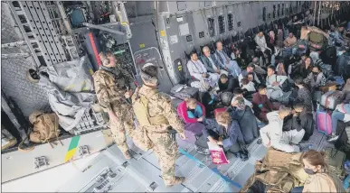  ?? Photo by Marc Tessensohn/Bundeswehr via Getty Images) ?? FLEEING evacuees from Kabul sit inside a military aircraft as they arrive at Tashkent Airport