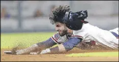  ?? JOHN BAZEMORE / ASSOCIATED PRESS ?? Dansby Swanson, diving into second base with a double against the Mets on Friday, seems to have bounced back in June from his late May slump.