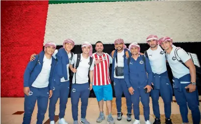  ??  ?? Cd Guadalajar­a players pose upon their arrival at the Abu dhabi internatio­nal Airport.