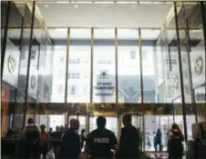  ?? JOHN TAGGART — THE WASHINGTON POST VIA AP ?? Police officers keep watch at Trump Tower in Manhattan, New York, on Thursday.