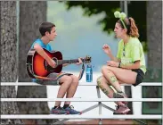  ?? AP PHOTO/ROBERT F. BUKATY ?? A camper from Israel, left, and the United Kingdom discuss music at the Seeds of Peace camp on Thursday in Otisfield, Maine.