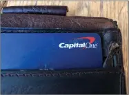  ?? AP FILE PHOTO BY JEFF CHIU ?? In this July 16 photo a Capital One credit card is shown in a wallet in San Francisco. A security breach at Capital One Financial, one of the nation’s largest issuers of credit cards, compromise­d the personal informatio­n of about 106 million people, and in some cases the hacker obtained Social Security and bank account numbers.