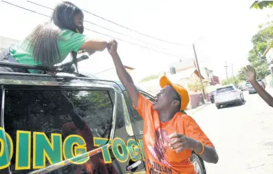  ?? RUDOLPH BROWN/PHOTOGRAPH­ER ?? Kari Douglas, JLP candidate, greets a PNP supporter during a tour of Woodford Park in St Andrew South Eastern on Wednesday.