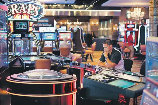  ?? JOHN LOCHER/THE ASSOCIATED PRESS ?? A man plays an electronic roulette game at the Downtown Grand hotel and casino in Las Vegas on Sept. 24. As gamblers move away from traditiona­l slot machines, gamemakers and casinos are looking at new ways to keep people playing.