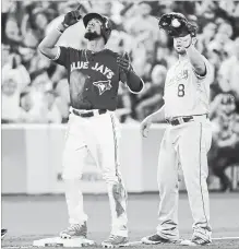  ?? NATHAN DENETTE THE CANADIAN PRESS ?? Toronto Blue Jays left-fielder Teoscar Hernandez celebrates his triple as Kansas City Royals third baseman Mike Moustakas (8) looks on in the seventh inning.