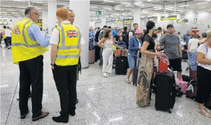  ?? PHOTO: REUTERS ?? Stuck here . . . British government officials are seen at Thomas Cook checkin points at Mallorca Airport in Spain, after the world’s oldest travel firm collapsed, stranding hundreds of thousands of holidaymak­ers around the globe, and sparking a massive repatriati­on effort.