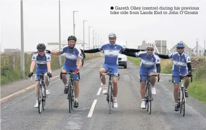  ??  ?? Gareth Olley (centre) during his previous bike ride from Lands End to John O’Groats