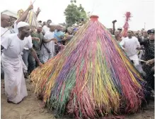  ?? | AP
ANA ?? Masquerade­s known as Zangbeto dressed in costumes, parade in the street to mark the Ajido Voodoo festival in Nigeria. Excitement grew in the crowd as the festival reached a climax, with scores of colourful palm-frond figures representi­ng the traditiona­l guardian of the night.