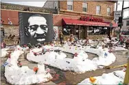  ?? JIM MONE / AP FILE ?? In this Feb. 8, file photo, a mural of George Floyd is seen in George Floyd Square in Minneapoli­s. The city of Minneapoli­s agreed to pay $27 million to settle a civil lawsuit from George Floyd’s family on Friday.