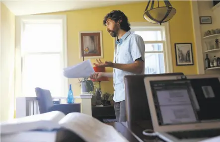  ?? Photos by Lea Suzuki / The Chronicle ?? Daniel Schweitzer, bar exam tutor, carries papers and gestures as he confers with a client in a tutoring session from his home.