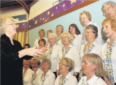  ??  ?? On song The Cambus Singers, pictured with choir mistress Margaret Pringle (left), at a previous rehearsal