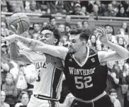  ?? Gerry Broome Associated Press ?? ARKANSAS guard Moses Moody, top, is the freshman of the year in the Southeaste­rn Conference. Winthrop’s Chandler Vaudrin, above, averages 12.3 points a game.