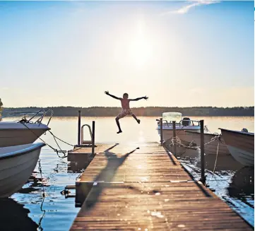  ??  ?? LAND OF THE LEAPING SON
Jumping off the jetty into the lake at Hellasgard­en, a few miles outside Stockholm