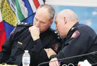  ?? GAVIN YOUNG ?? Acting police Chief Steve Barlow and Deputy Chief Paul Cook talk at the monthly police commission meeting on Tuesday, where Barlow noted police are collecting data related to the legalizati­on of cannabis.