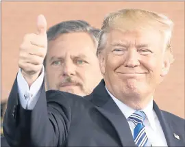  ?? STEVE HELBER — THE ASSOCIATED PRESS ?? President Donald Trump gives a thumbs up in front of Liberty University president Jerry Falwell Jr. Falwell is among many religious conservati­ves who suspect the Supreme Court vacancy ultimately will lead to the reversal of the landmark abortion case...