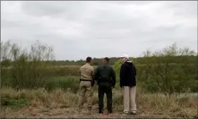  ?? AP PHOTO/eVAn VUCCI ?? In this Jan. 10 file photo, President Donald Trump (far right) tours the U.S. border with Mexico at the Rio Grande on the southern border in McAllen, Texas.