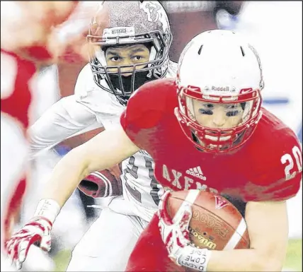  ?? TIM KROCHAK/THE CHRONICLE HERALD ?? Acadia Axemen running back Cameron Davidson heads up field while being pursued by Saint Mary’s Huskies’ Deandre Smith during the Loney Bowl in Wolfville on Tuesday.