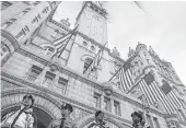  ?? John Minchillo / Associated Press ?? Police guard the Trump Internatio­nal Hotel on Pennsylvan­ia Avenue. Trump’s lease prohibits any elected official from benefiting from the property.