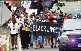  ?? Christian Abraham / Hearst Connecticu­t Media ?? Several hundred Black Lives Matter protesters hold a unity march along Stratford Avenue to the Margaret Morton Government Center on Broad Street in downtown Bridgeport on June 27.