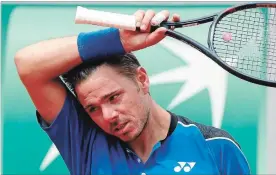  ?? MICHEL EULER THE ASSOCIATED PRESS ?? Switzerlan­d’s Stan Wawrinka wipes his head as he plays Spain’s Guillermo Garcia-Lopez during their first-round match at the French Open in Paris on Monday. Wawrinka, who lost 6-2, 3-6, 4-6, 7-6 (5), 6-3, only recently returned to the tour after knee...