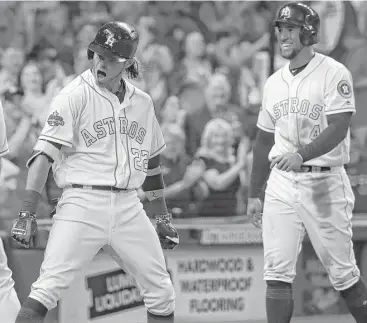  ?? Karen Warren photos / Houston Chronicle ?? Josh Reddick, left, lets out a roar as mighty as his grand slam in the seventh inning Tuesday night at Minute Maid Park. Astros teammate George Springer was equal parts amused and appreciati­ve of the outburst.