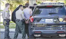  ?? Chris Torres/The SIgnal ?? Santa Clarita Valley Sheriff’s Station deputies detain one while responding to a report of an assault next to Meadows Elementary School Thursday.