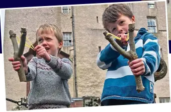  ??  ?? Creating their own fun: Harry, left, and Ollie play with catapults they’ve made