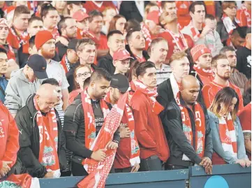  ??  ?? Liverpool fans observe a minute’s silence for victims of the Manchester terror attack before their end-of-season friendly football match against Sydney FC at the Olympic Stadium in Sydney. — AFP photo