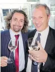  ??  ?? Davide Orru offered Italian consul-general Massimilia­no Iacchini a glass of Monte Schiavo wine from the latter’s Adriatic Coast Marche region.