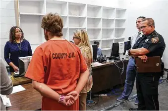  ?? Jon Shapley / Houston Chronicle ?? Judge Maria Jackson, left, listens as Stephanie Martin, a defense attorney, argues her client’s case in the 339th District Court, which is temporaril­y located in the basement of the Harris County Jail.