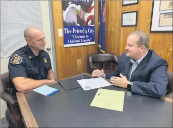  ?? PHOTO COURTESY OF HAZEL PARK ?? Hazel Park City Manager Ed Klobucher, right, talkswith Police Chief Brian Buchholz at City Hall. Klobucher says community policing efforts and residents’ support of police have created a bond that has made the city safer and more stable.