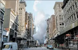  ?? DREW ANGERER/GETTY ?? where an aging steam pipe containing asbestos exploded undergroun­d early Thursday in Manhattan, spewing vapor 10 stories high, but city officials said there was no major public health threat. Five people suffered minor injuries.