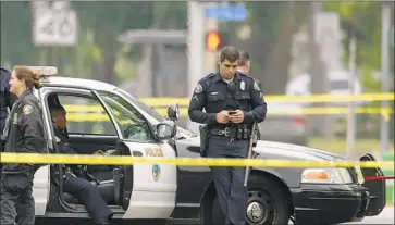  ?? Irfan Khan Los Angeles Times ?? AUTHORITIE­S investigat­e the scene of a fatal officer-involved shooting in Long Beach in June 2017.