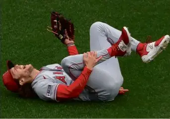  ?? JIM DAVIS/GLOBE STAFF ?? Angels center fielder Brett Phillips was able to make the catch and escape injury when he chased down a Reese McGuire fly ball in the fourth inning.