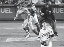  ?? ASSOCIATED PRESS ?? SAN DIEGO PADRES’ CHRISTIAN VILLANUEVA (left) heads to first on a two-run home run as Los Angeles Dodgers catcher Yasmani Grandal and starting pitcher Alex Wood watch along with home plate umpire Brian Knight during the sixth inning of Saturday’s game...