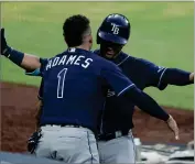  ?? AP PHOTO BY JAE C. HONG ?? Tampa Bay Rays’ Willy Adames, left, celebrates with Michael Perez after Perez hit a two-run home run against the New York Yankees during the sixth inning in Game 3 of a baseball American League Division Series, Wednesday, Oct. 7, in San Diego.