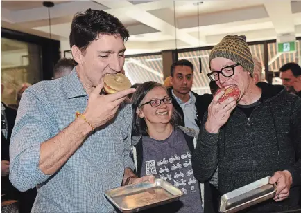  ?? BARRY GRAY THE HAMILTON SPECTATOR ?? Prime Minister Justin Trudeau, left, stopped by Donut Monster on Locke Street South on Tuesday morning to chat with owner Reuben Vanderkwaa­k during a visit to the city. Vanderkwaa­k’s shop was among those vandalized during a mob’s rampage on March 3.