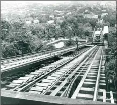  ??  ?? The James Street Incline started operations in 1892 and was abandoned in 1932. LEFT: One of the cars of the East-End Incline Railway carrying a man and his bike nears the bottom.