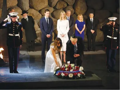  ?? (Jonathan Ernst/Reuters) ?? US PRESIDENT Donald Trump and first lady Melania Trump lay a wreath to commemorat­e the Holocaust, in the Hall of Remembranc­e at Yad Vashem in Jerusalem yesterday.