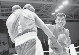  ?? AFP PHOTO ?? Philippine­s’ Charly Suarez ( right) fights with India’s Akhil Kumar in the men’s boxing light welter 60 kg preliminar­ies session 6 during the 2014 Asian Games in Incheon on September 26, 2014.