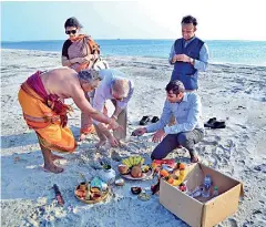  ?? ?? The Indian High Commission team led by new High Commission­er Santosh Jha holding a pooja on the second shoal in the Adam's Bridge area