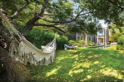  ?? Eric Laignel/Rottet Studio via AP ?? This photo provided by Rottet Studio shows a backyard designed by architect and interior designer Lauren Rottet in Montauk, N.Y. Adding a cozy hammock as Rottet did in this backyard, brings beauty and comfort and can be especially useful if you’re staying home for much of this summer.