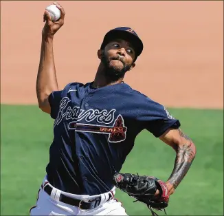  ?? PHOTOS BY CURTIS COMPTON/CURTIS.COMPTON@AJC.COM ?? Carl Edwards Jr. has made two appearance­s this spring, striking out three and giving up one run. He needs to beat out Grant Dayton or Luke Jackson for a roster spot.