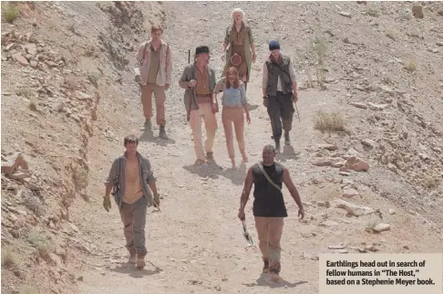  ??  ?? Earthlings head out in search of fellow humans in “The Host,” based on a Stephenie Meyer book.