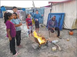  ?? Abdel Kareem Hana Associated Press ?? GAZANS displaced by Israel’s military offensive find shelter at a camp in Deir al Balah. The war has forced some Palestinia­ns to f lee their homes multiple times.