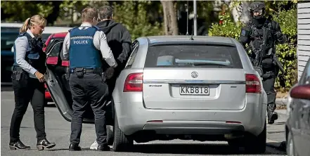  ?? STUFF ?? Police officers arrest a 41-year-old man in Cotterll St, Addington, yesterday.